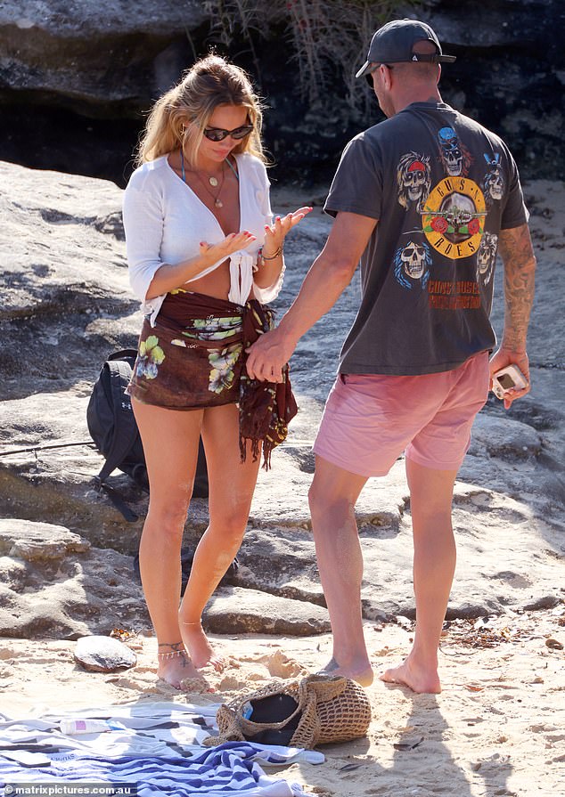 Evan covered himself in a Guns N' Roses t-shirt as they left the beach.