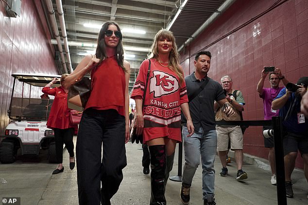 Taylor paired her Chiefs jersey with thigh-high boots and smiled as she arrived at the stadium.