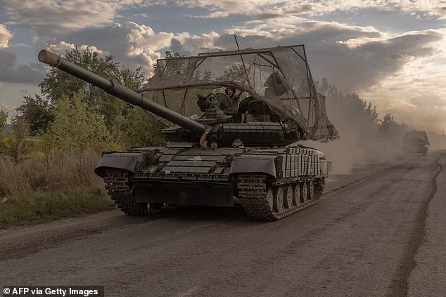 Ukrainian servicemen drive Soviet-made T-64 tanks in the Sumy region on August 11.