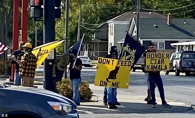 Proud Boys members carried flags and signs.