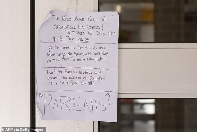 A note on the door of Fulton Elementary School directing parents where to pick up their children after a bomb threat.