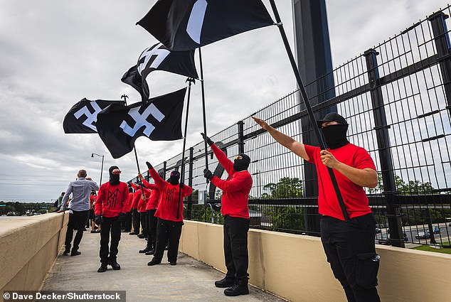 Members of the neo-Nazi armed group Blood Tribe, pictured in Florida, held a march in Springfield last month and helped spread rumors about pet eating online.