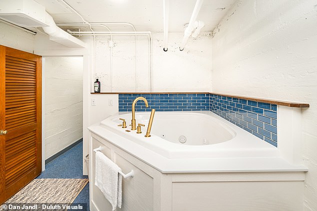 The house has five elegant bathrooms with navy blue details.