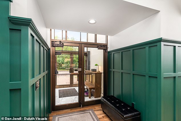 The foyer area was preserved and painted emerald to match the interior of the house.