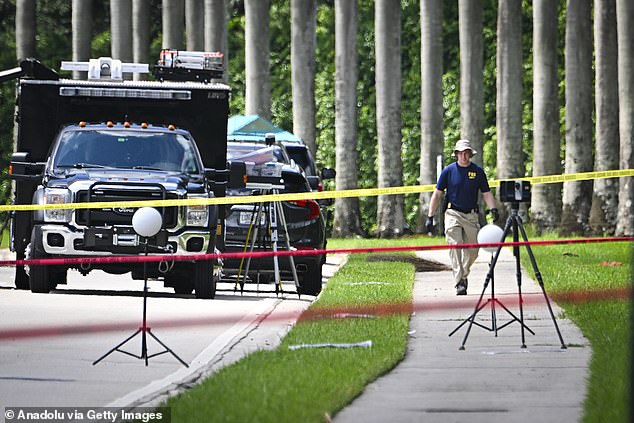 Police personnel investigate the area around the Trump International Golf Club