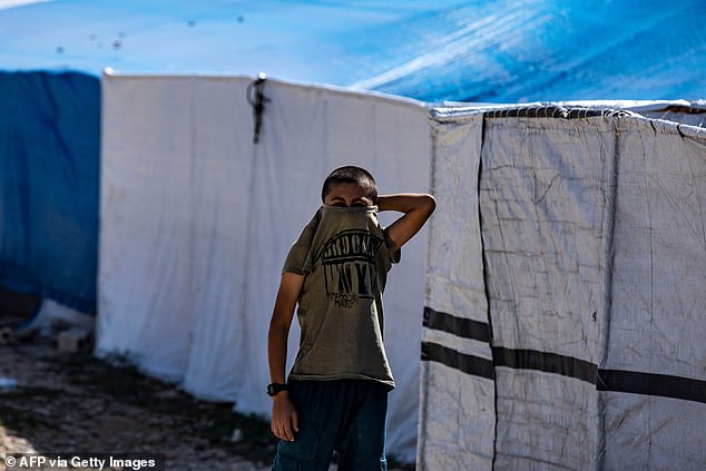 A child living in Al-Roj camp is photographed in October last year.