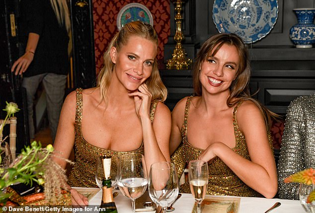 Poppy sat next to designer Annie Noble for dinner, and the pair matched in her gold dress.