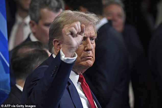 Trump gestures as he speaks to members of the press in the press room after a presidential debate