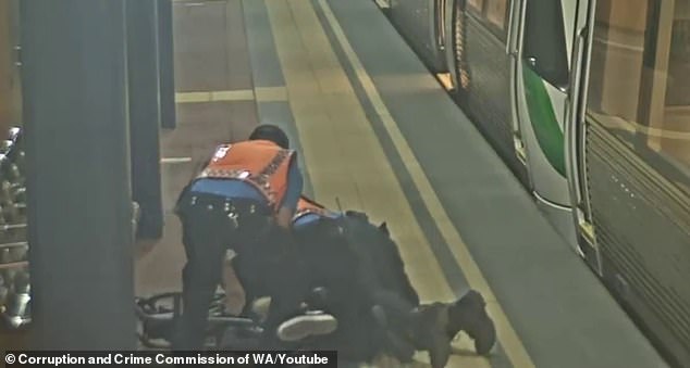 Two traffic officers in Perth are seen tackling the passenger to the ground.