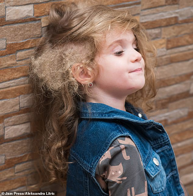 Sofija, now three, appeared to have almost straight hair, but only on one side. The other side was covered in a mix of large, loose curls and tight afro curls.