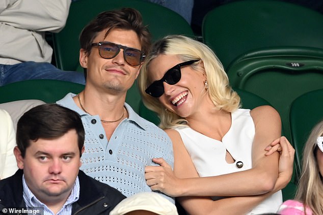 The singer and actress met her current husband, model Oliver Cheshire, 36, a year after shooting to fame on a catwalk show in 2010 and they got engaged in 2016, married in 2022 and then welcomed their son in November (pictured together at Wimbledon in July).