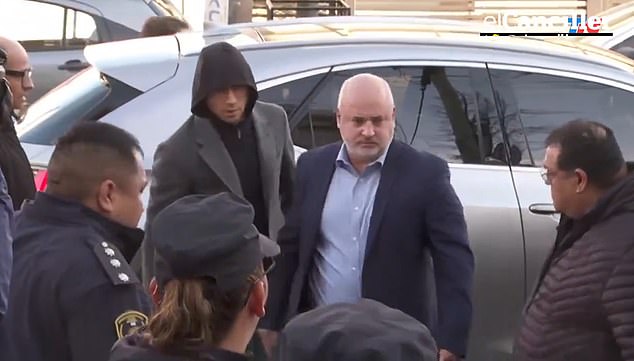 Argentine soccer player Gonzalo Montiel is seen with his lawyer arriving at the prosecutor's office in the Buenos Aires city of La Matanza on Tuesday morning for a psychiatric evaluation after the athlete and a friend were formally charged with raping his ex-girlfriend.