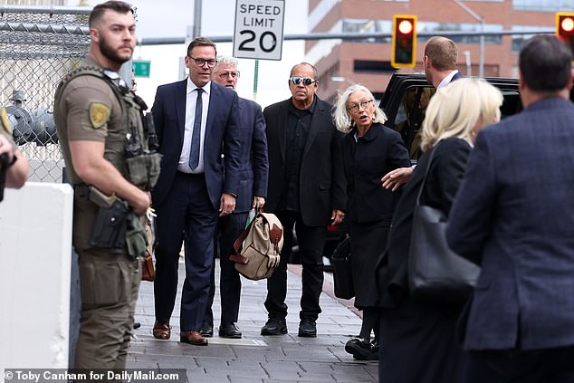 James, 51, and Prudence arrive at the courthouse with security in tow on Tuesday.