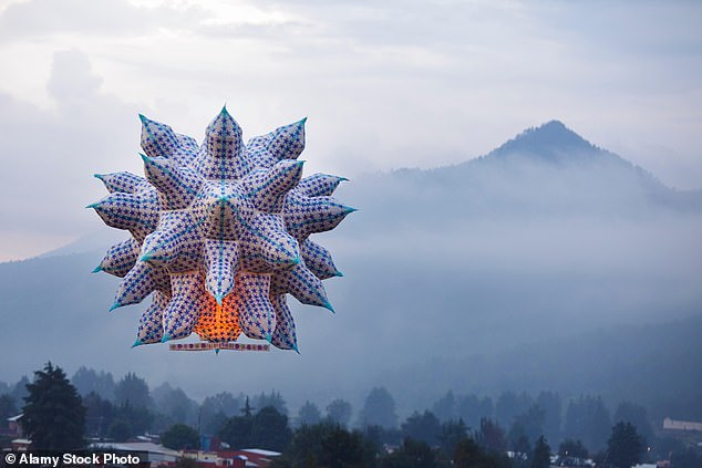 A large flying lantern floats toward a mountain outside Paracho, a city in the western Mexican state of Michoacan, during the annual Globos de Cantoya festival.