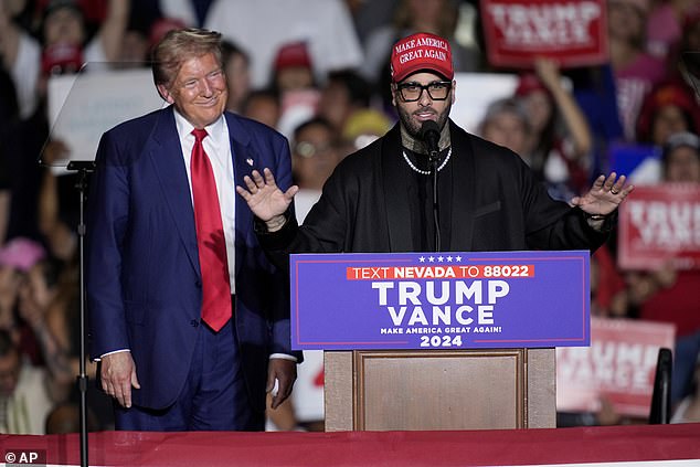 Nicky Jam speaks with former President Donald Trump at his rally in Las Vegas on September 13. The former president made a mistake when referring to the Latin singer when he said 