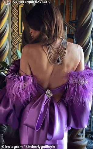 In one video, she is seen seductively blowing a kiss to the camera and showing off her exposed back in the eye-catching purple dress.