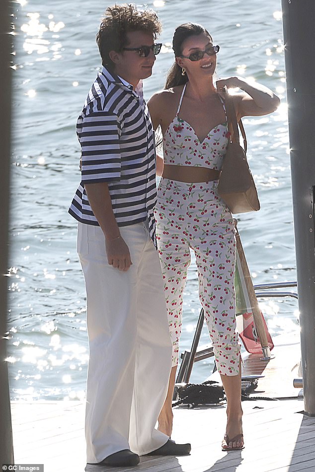 Charlie looked relaxed in a striped shirt and white pants, while Brooke wore a matching bra and pants set with a cheerful pattern.