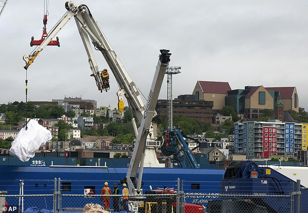 The remains of the Titan submersible, recovered from the ocean floor near the wreck of the Titanic, are unloaded from the Horizon Arctic ship at the Canadian Coast Guard pier in St. John's, Newfoundland, June 28, 2023.