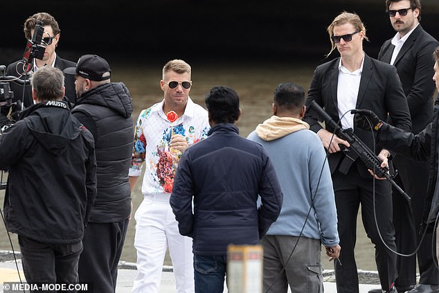 He terrorized the men in suits and machine guns surrounding him on the floating dock by pretending to shoot one of them with his lollipop.