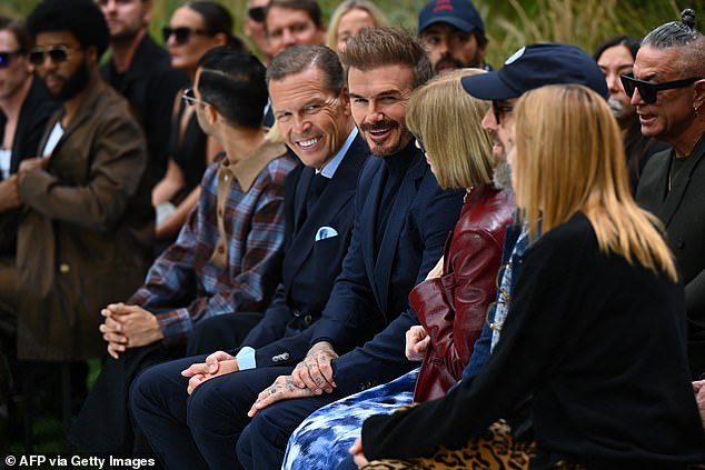 The couple appeared to be laughing as they watched the outdoor spectacle.