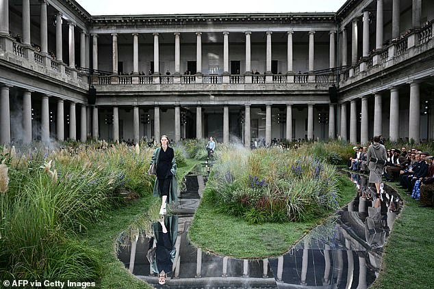 The show took place outdoors, in the gardens, on a mirrored catwalk.