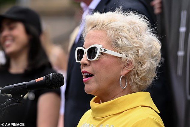 Critical British transgender activist Kellie-Jay Keen-Minshull speaks on the steps of Parliament House in Melbourne on March 18, 2023. Victorian MP Moira Deeming is pictured to her right.