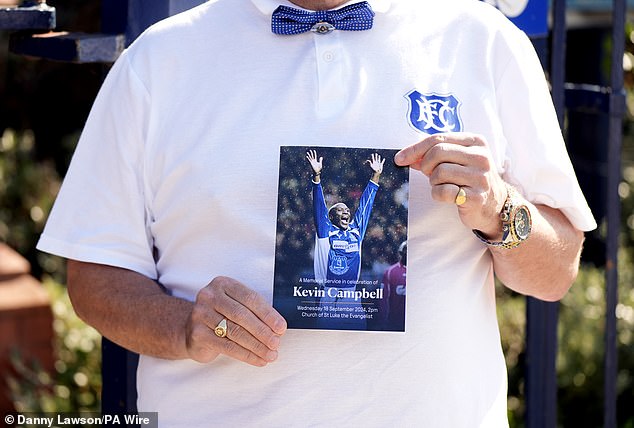 The memorial service program showed Campbell with his arms raised and a beaming smile on his face.