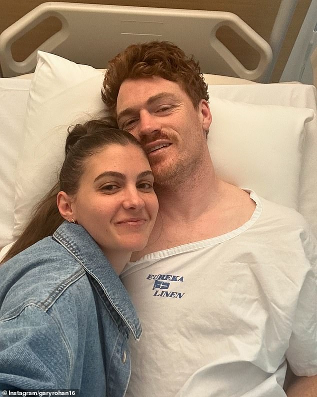 Rohan posted a hospital photo with his wife Madi (pictured) as he awaited surgery after suffering a horrific injury during a VFL match.