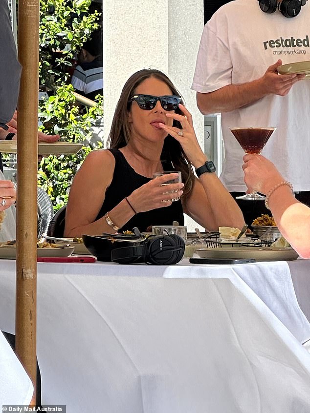 Candice, 39, dressed elegantly in a simple yet chic sleeveless black blouse paired with stylish sunglasses, looked focused as she took part in the discussion.