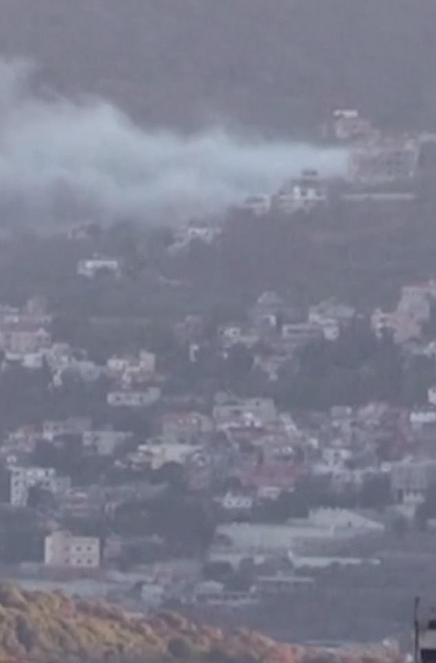 A thick cloud of smoke hangs over a settlement after a second wave of explosions rocked Lebanon