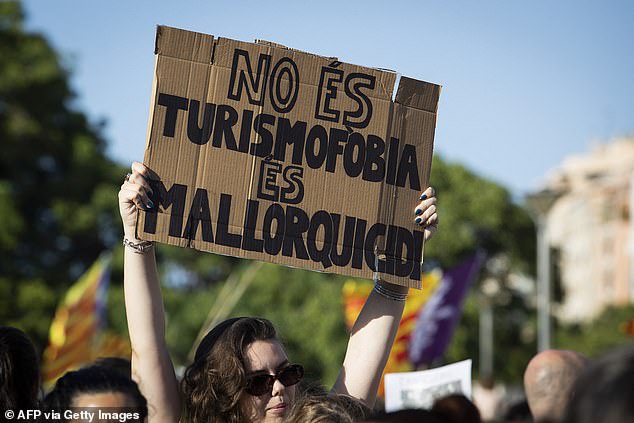 A protester holds a sign that reads 