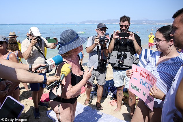 A protester speaks during a demonstration on the beach in Palma de Mallorca in August.