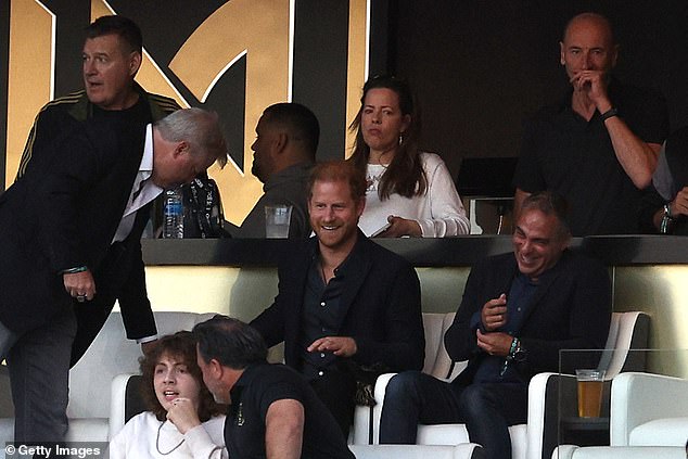 Urias was accused of assaulting his wife after attending the same MLS soccer match as Prince Harry (center)