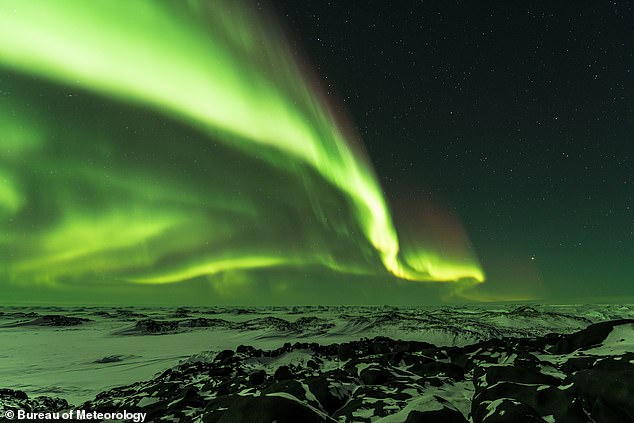 The colorful light show occurs when a solar storm descends on Earth, bringing particles that interact with gases (archive photo of Aurora Australis over Antarctica)