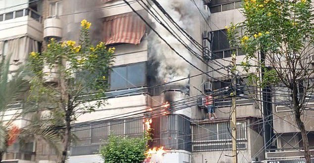 Flames rise to a building in Lebanon amid explosions