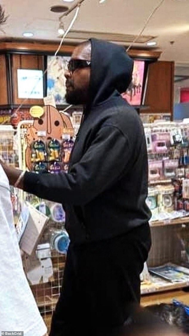 Meanwhile, the hip hop star stayed covered up in a black hoodie, matching pants and a pair of sunglasses.