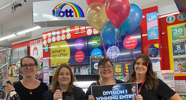 The ticket was sold on The Lott app and not in a store. Pictured are workers at a Lotto kiosk