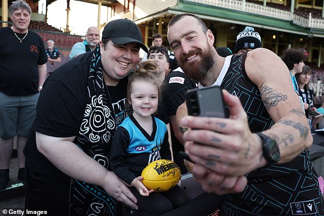 The setback will have left some Power fans panicking over how they will get to the SCG in time for the game (pictured, supporters with Port star Charlie Dixon)