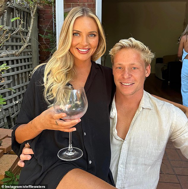 The decorated Swans midfielder, who will play his 200th game for the Swans on Friday night, is pictured with his girlfriend Steffie Waters.