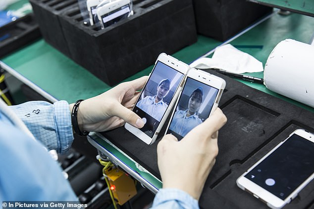 Employees and smartphones on the assembly line at the OnePlus manufacturing plant in Dongguan, China