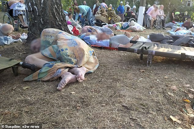 Pensioners lie on the ground outside the building after the indiscriminate attack by Putin's forces