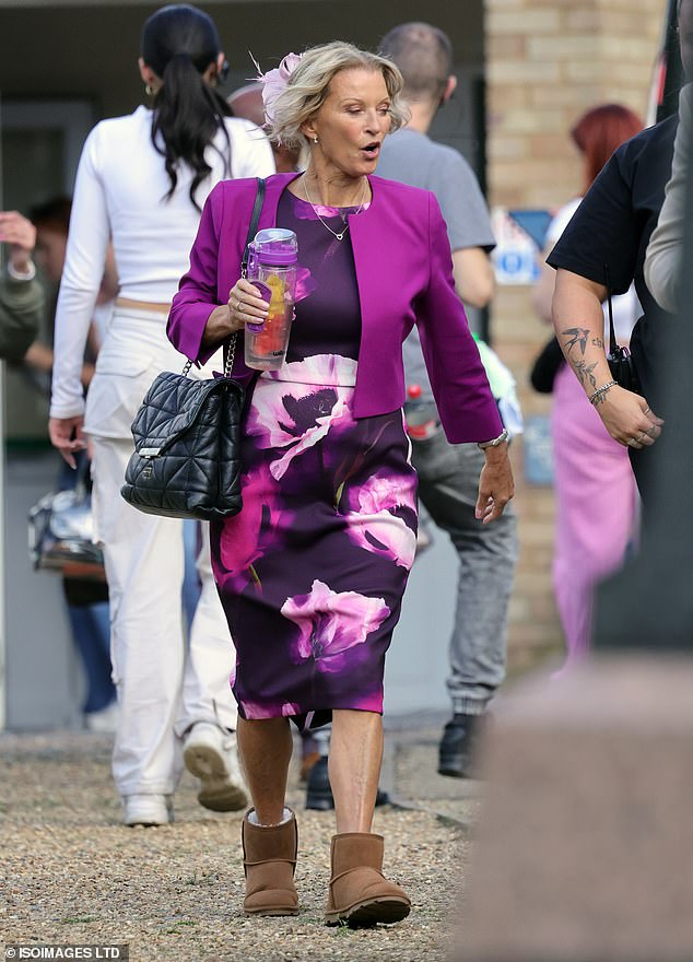 The actress, who has played Kathy Beale since 1985, showed off her age-defying look in a bright pink outfit as she was spotted between scenes.