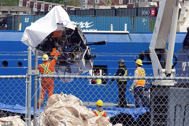 The remains of the Titan submersible, recovered from the ocean floor near the wreck of the Titanic, are unloaded from the ship Horizon Arctic at the Canadian Coast Guard dock in St. John's, Newfoundland, Wednesday, June 28.