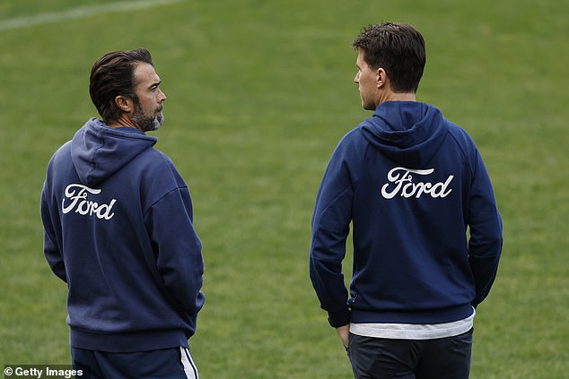 Geelong Cats coach Christ Scott speaks with general manager of football Andrew Mackie at the training session.