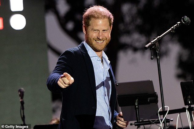 The Duke of Sussex opted for a navy suit jacket with a light blue shirt as he took to the stage.