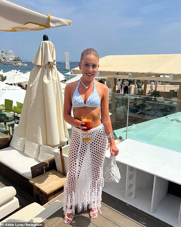 Just a few weeks ago, Abbie was soaking up the sun in Mallorca, and in one photo she looks stunning in a blue bikini and white crochet skirt as she posed on Nikki Beach.