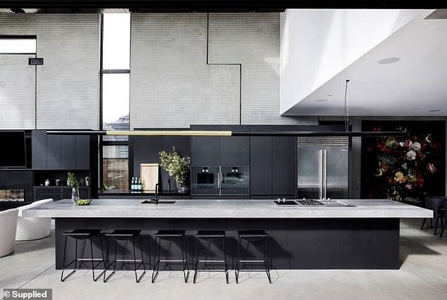 Freedom posted glowing photos of the meticulously designed kitchen and it's evident that Guy and Jules spared no expense. The luxurious kitchen inside the mansion features a large Caesarstone island, with unconventional cabinetry in dark tones.