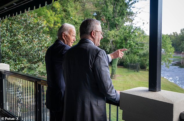 Biden points out the lake to Albanese as he shows him his home