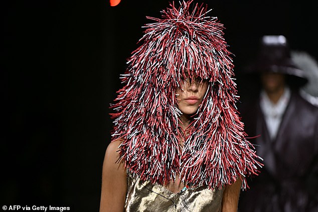 The models were able to walk in a straight line, even though the headdresses apparently covered their eyes.