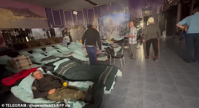 Evacuees rest in an emergency shelter after their evacuation from an area attacked by a Ukrainian drone on September 21.